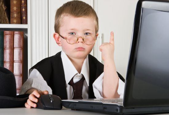 Four year old boy playing angry boss in his office